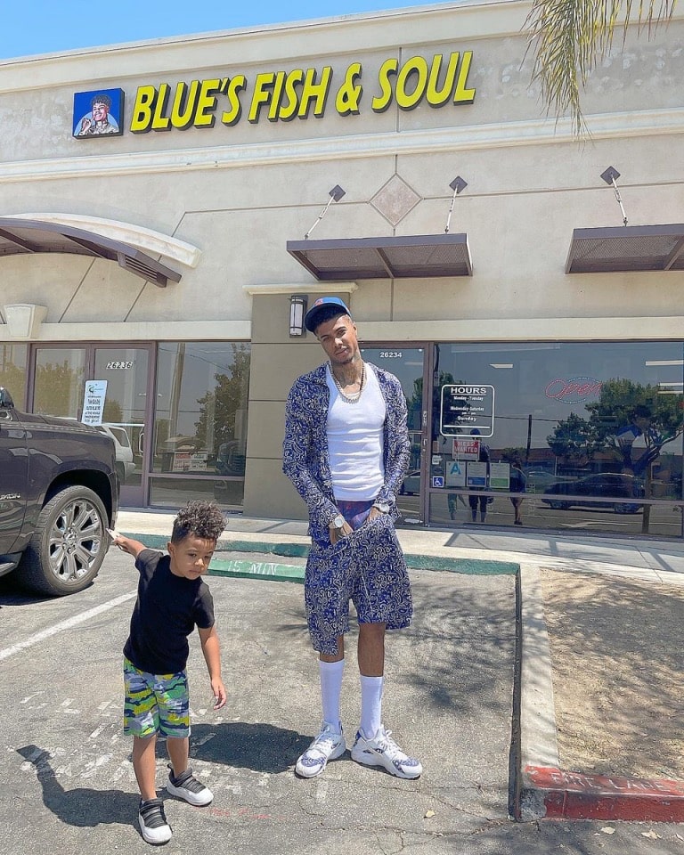 Blueface and his son in front of the Blue's Fish and Soul 